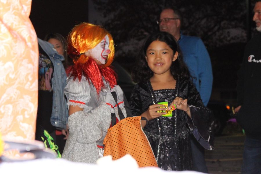 Two girls enjoy candy and each others company walking around Fun Night. Photograph by Katie Ball
