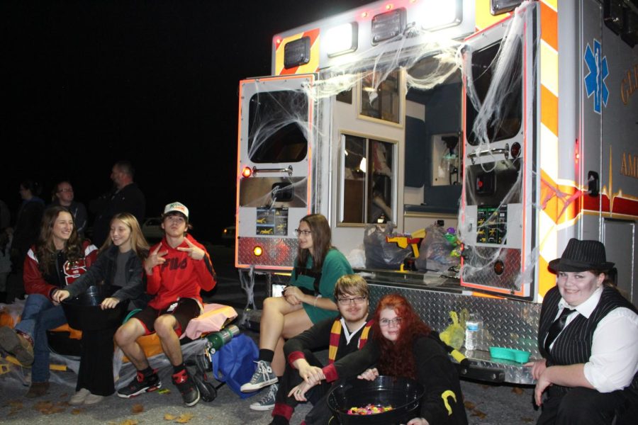 Students from the new EMT class hand out candy from an ambulance. 
The Glen Rock ambulance was decorated with cobwebs and candy. Students were dressed in an array of costumes from pop culture, such as from the hit franchise “Harry Potter.” Photograph by Katie Ball