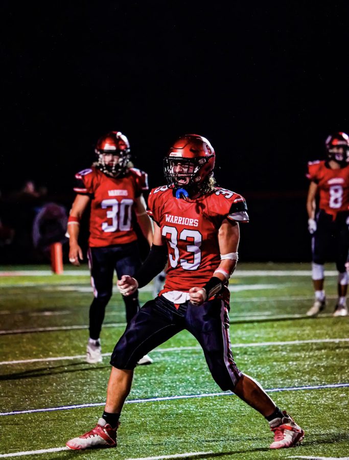 Sophomore Dawson Zorbaugh reacts after a defensive stop during the 2022 season. Zorbaugh earned first team honors on the YAIAA Division II All-Star team for defense. He led the Warriors defense with 7.8 tackles per game and 4 sacks. Photograph courtesy of Naber Photography
