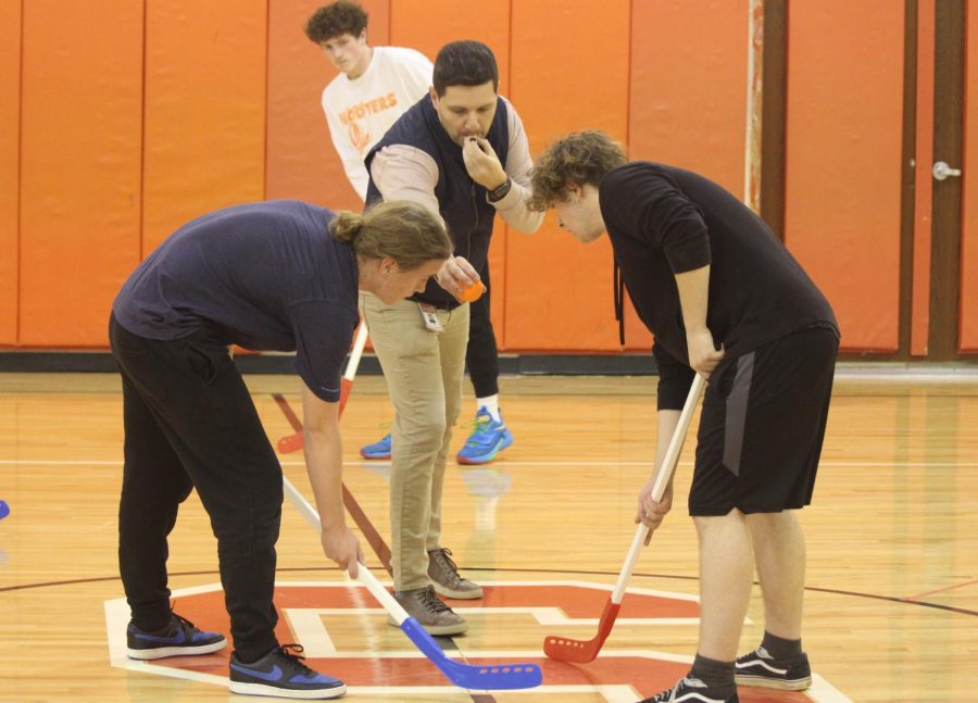 Student Council advisor Andy Warren drops the puck to start a game between he Sons of Sturgill and The Dream Team during the Winter Olympics floor hockey competition.
Photograph by Richard Harper