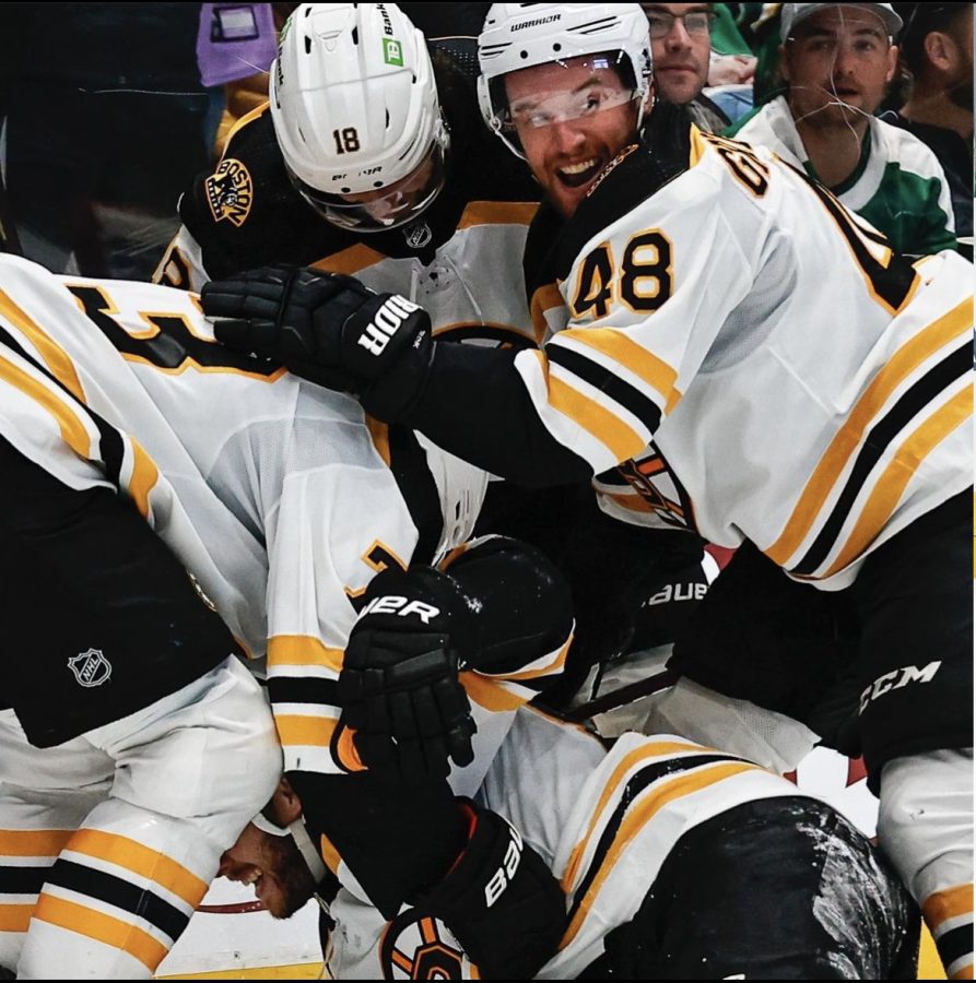 The Bruins team piles on David Pastrnak after his star performance. Photograph Courtesy of @nhlbruins via Instagram 