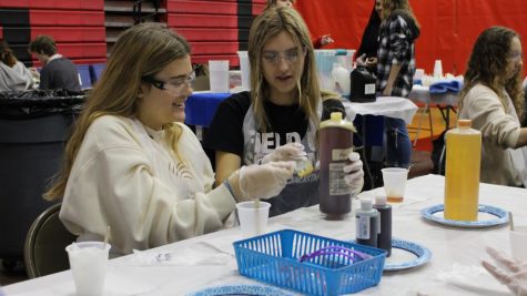 9th graders Maddy Mechling and Keely Lipka participate in the biology activity during the STEM Summit by Junior Achievement on Jan. 20. This was the first STEM Summit hosted by the high school since 2020. 
Photograph by Kate Ball 
