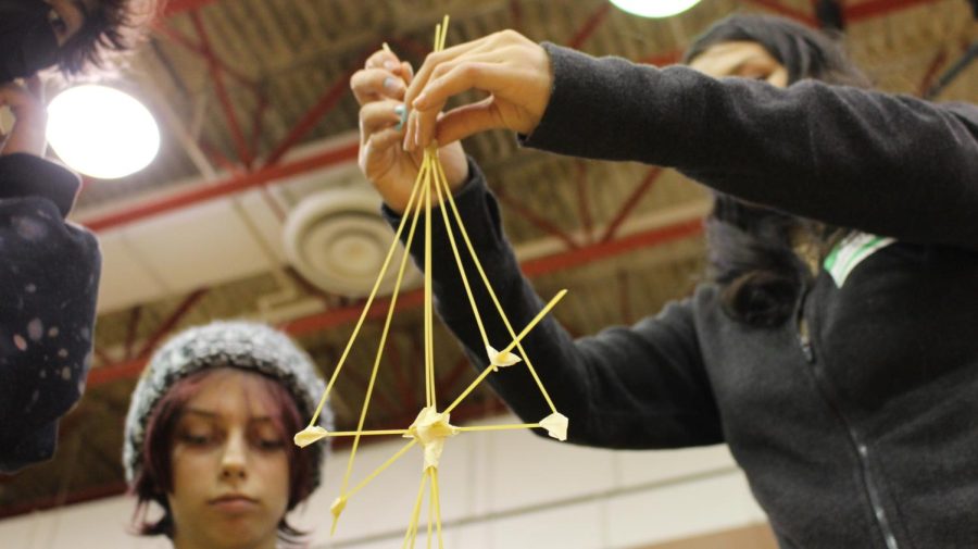 At the engineering station, students build a spaghetti tower using innovation. 
Photograph by Kate Ball