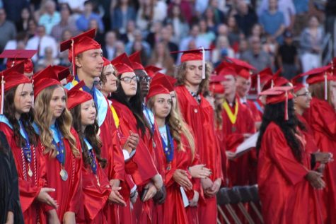 Members of the class of 2023 listen to the Alma Mater during the Commencement ceremony on May 25.
Photograph by Kendall Woods