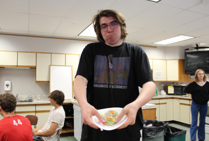 Junior Jacob Stroh proudly shows off his cookie decorating skills in the cookie decorating room.
