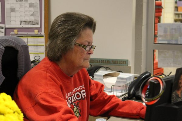 Miss Grace sits focused at her desk. Photograph courtesy of Eric Stover