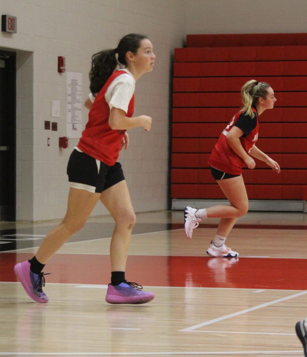Senior Georgie Snyder and sophomore Chloe Jackson  run sprints during a practice before the start of the 2023-24 season. Head coach Alex Fancher has the players focus on numerous skills during practices.
We do ball handling, shooting, Fancher said. We’ll do some defensive drills, and do some rebounding and passing.   
Photograph by Kendall Single