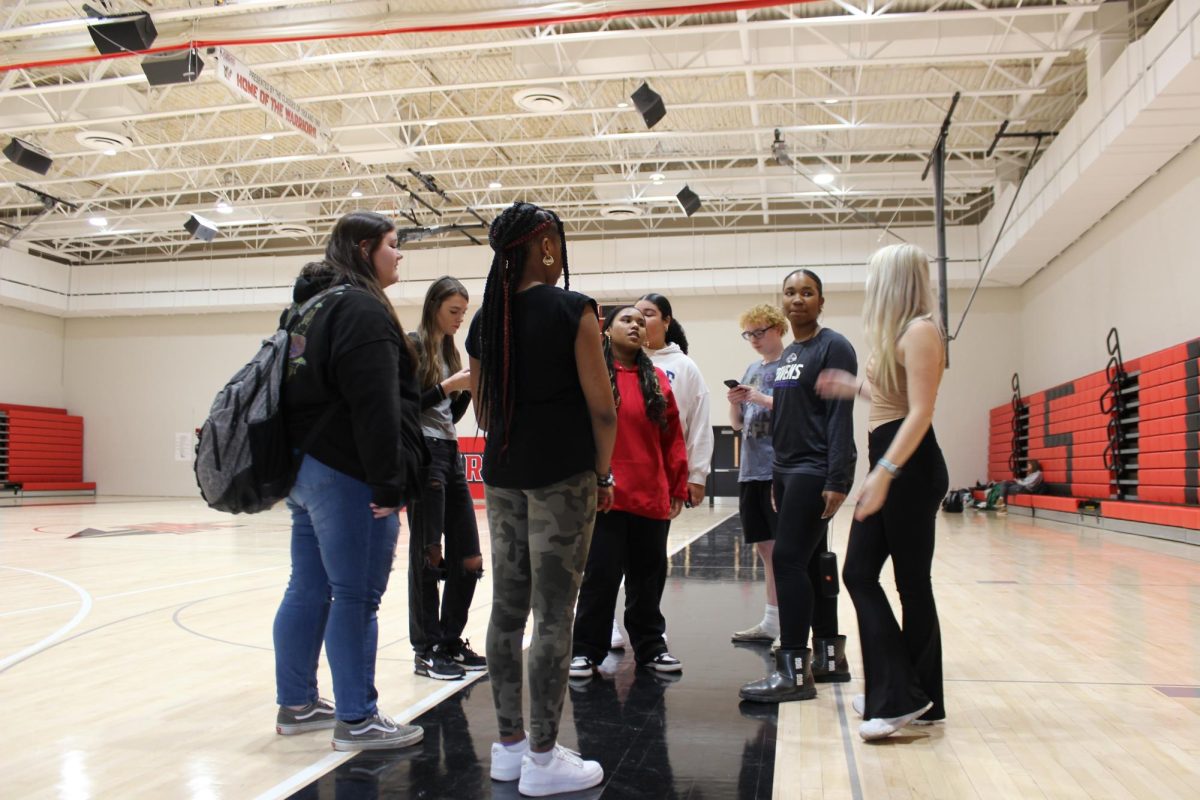 The step team discusses all the dates and times before they start  a practice in late December. ”Our practice starts with upcoming announcements, then I teach steps and lay out the performance,”Jones said.
Photograph by Nele Froehlingsdorf
