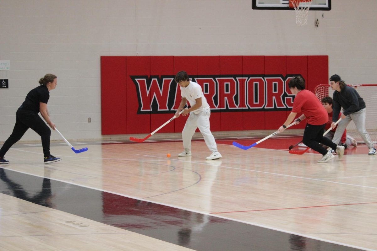 Junior Rafi Hernandez keeps the ball away from defenders in a floor hockey game during the annual SHS Winter Olympics. Student Council hosts the Winter Olympics to bring awareness and excitement to the holiday season. Junior Erin Jackson, an eleventh-grade representative for Student Council, helped organize this event.  “Some benefits to the student body is that all different kinds of students can be involved in the games, and everyone has a fair shot. We do it because it’s also a lot of fun to watch,” Jackson said.
Photograph by Kendall Single
