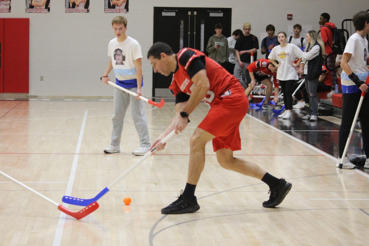 Math teacher Ryan Liephart participates as part of the teacher team during the Winter Olympics final game during a pep rally on Dec. 22. “One of the best memories was definitely when Colin Hebel’s team beat Owen’s team. It was very competitive and the comeback was crazy. It was so fun to watch because it was so unexpected,” Jackson said.
Photograph by Kendall Single
