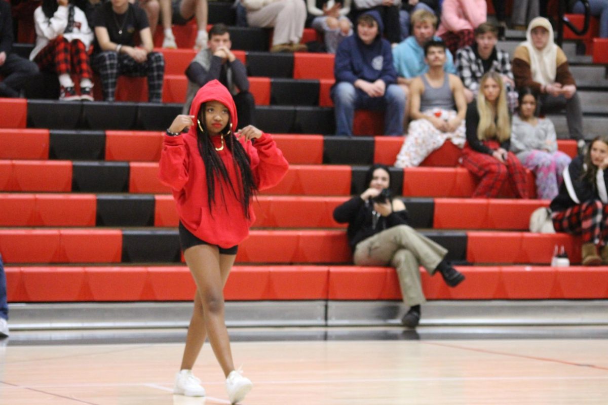 Sophomore Layla Holmes performs with the step team at the Winter Olympics pep rally on Dec. 22. The step team is a mixed group of girls and boys and all of them work together during the week to learn new steps. “We have seven steppers on the team, Jones said.
Photograph by Kendall Single