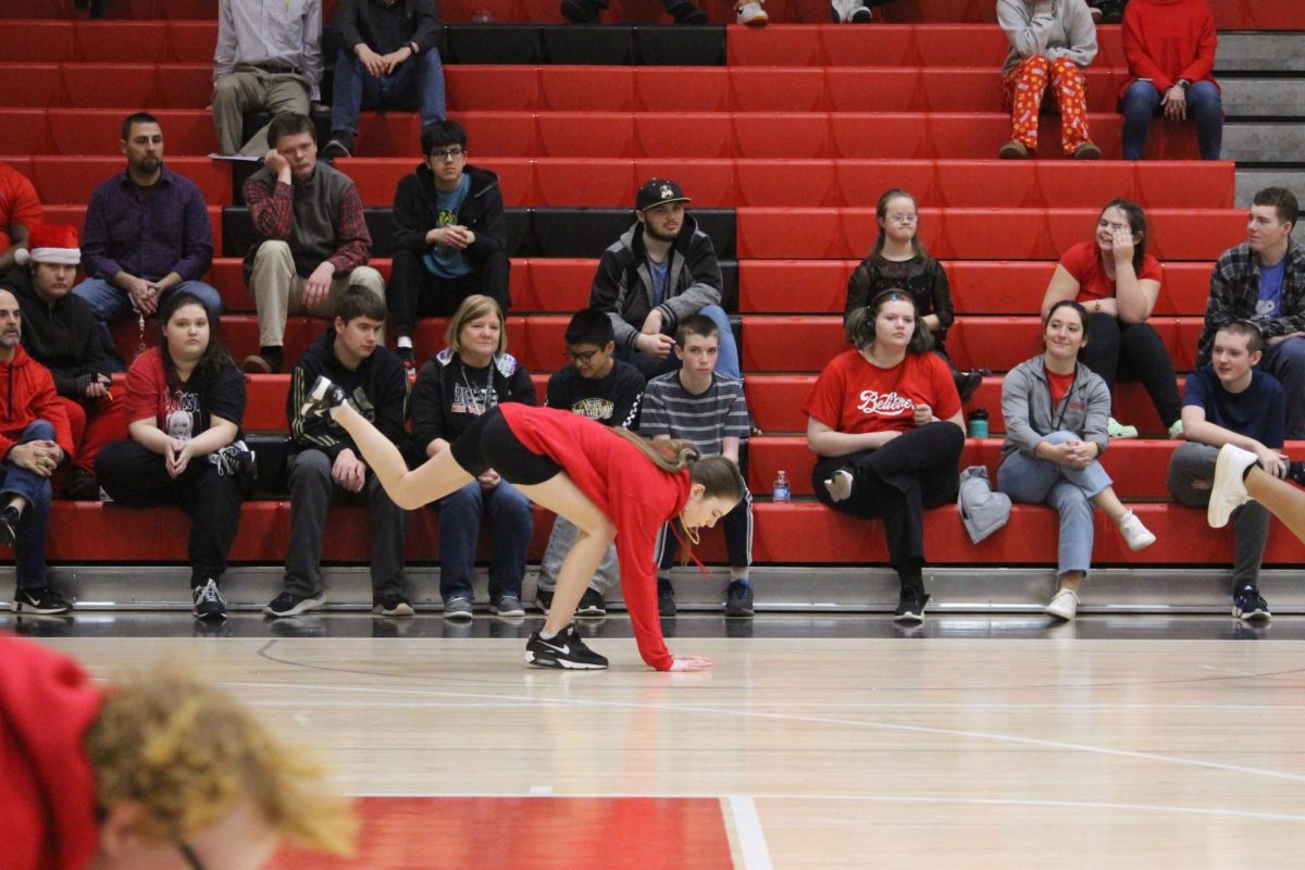 Sophomore Ava Hayford performs a step move by using the floor to clap on it.
Student-coach Zoey Jones creates the shows for her steppers to learn it before every other halftime show of the basketball games. “It takes me about a week to learn [and create] the choreography,” Jones said.
Photograph by Kendall Single