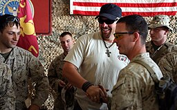 Country music star Toby Keith greets Iraq-deployed U.S. service members May 29, 2006.
Photograph by Slick-o-Bot in Public domain, via Wikimedia Commons