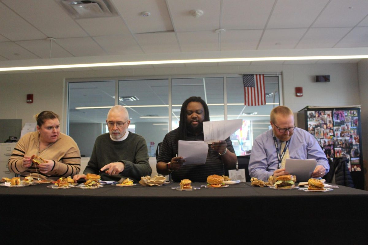 The judges evaluate each burger and take notes, trying to decide which burger was their favorite. Six different teams presented their creations to the judges.  Photograph by Josie Witsik
