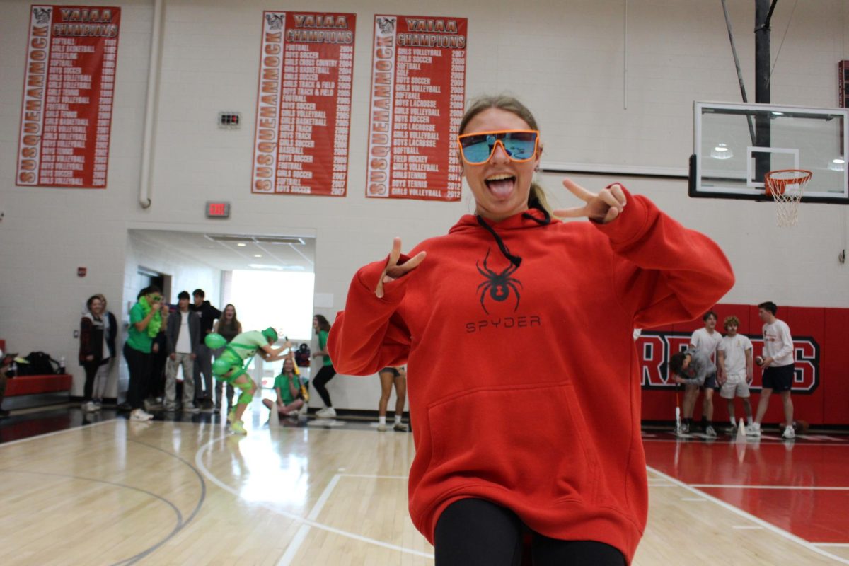 Freshman Abigail Retzlaff has a fun time posing for a picture mid-competition. Photograph by Josie Witsik. 