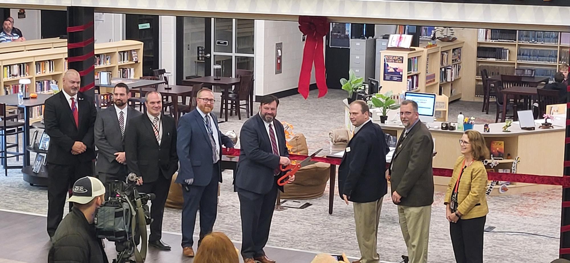 Bryson poses for a photo alongside his fellow administrators before cutting the ribbon. Photograph courtesy of Bill Russell