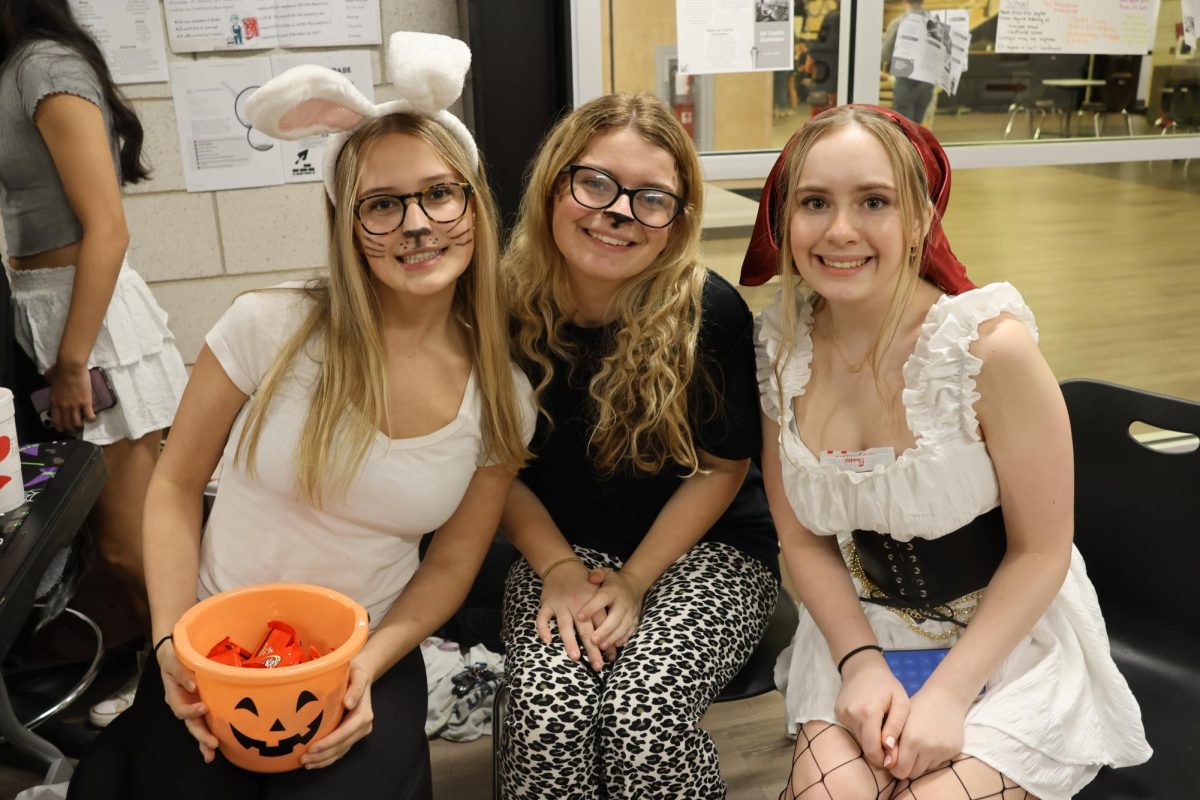 Senior Kylee Grim and sophomores Autumn Miller and Roxy Mason show off their costumes while representing SHS Cheer at Family Fun Night on Oct. 30. For the fourth year in a row, Student Council had to adjust the route for trick-or-treaters to accommodate closed parts of the building due to construction. “It's awesome to see how animated students can get when they are working on events and projects that are exciting about bringing to life,” Student Council advisor Allison Altemose said. Photograph by Christina Iwanowicz