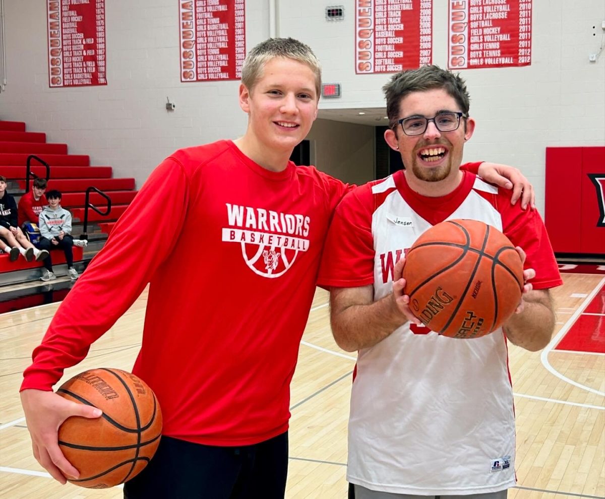 Sophomore Luke Wilson helped alumnus Jenson Perry(Class of 2019) improve his dribbling and shooting skills during the Court of Dreams basketball clinic. 
Photograph by Kelsey McCullough