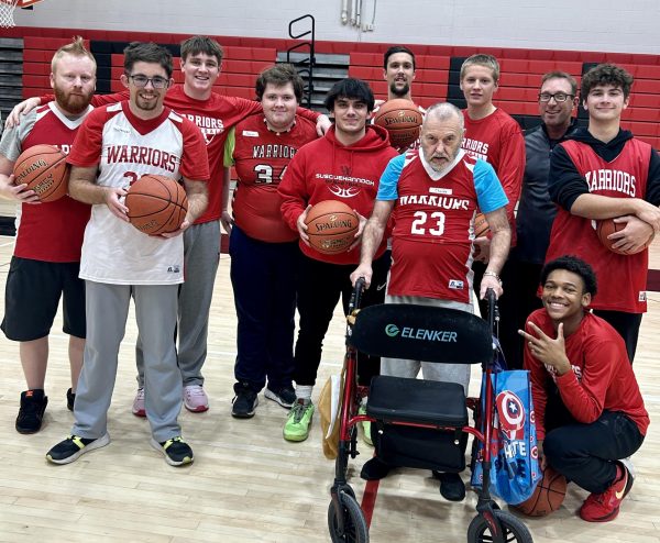 Members of the boys basketball team pose with attendees of the Court of Dreams basketball clinic on Dec. 5.
Photograph by Kelsey McCullough