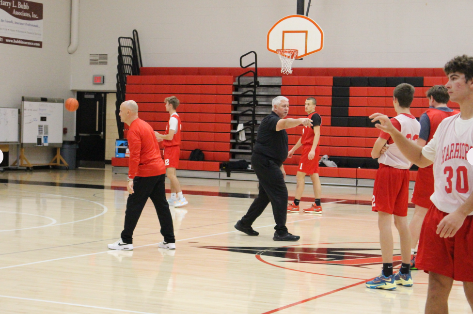 Boys basketball assistant coach Tom Laure (left) and head coach Wayne McCullough organize players for a shooting drill during a practice in late November. Photograph by Bryleigh Supa