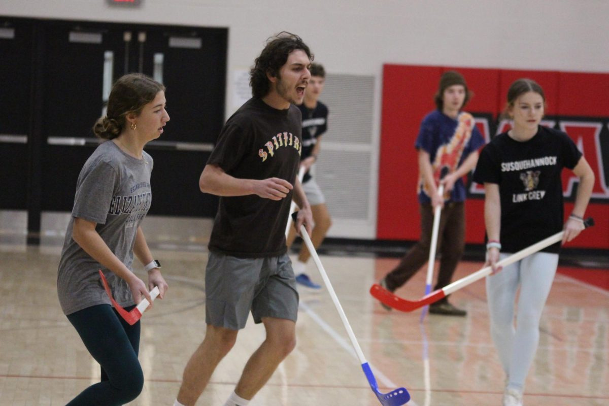   Senior Aiden Green is ‘pumped up’ as his teammates go for the goal. “Winter Olympics is the opportunity to bring students together and provide them something fun to look forward to halfway through the school year,” Altemose said. 
Photograph by Josie Witsik