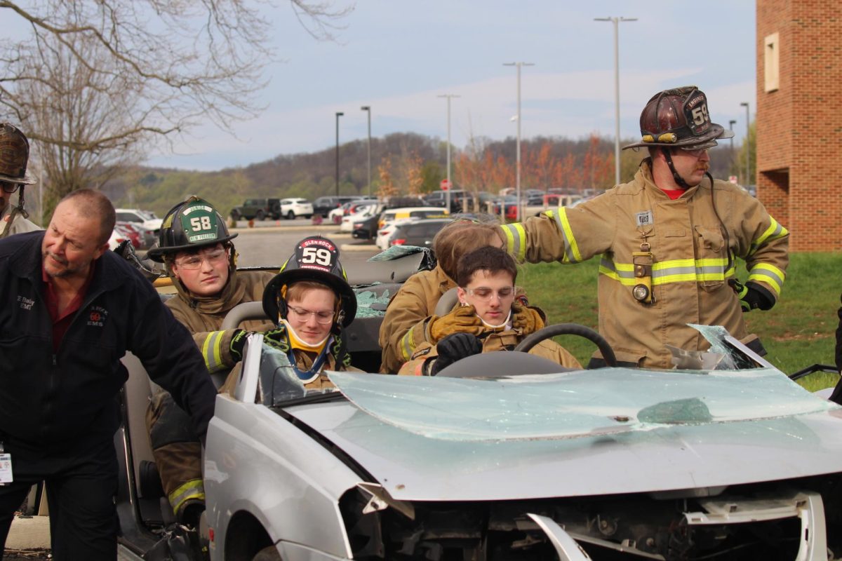 E.M.T. students practice implementing a neck support.
:Supporting someone's neck after an accident is crucial to prevent further injury, especially spinal cord injuries, and can be life-saving. photograph by Peyton Elmore

