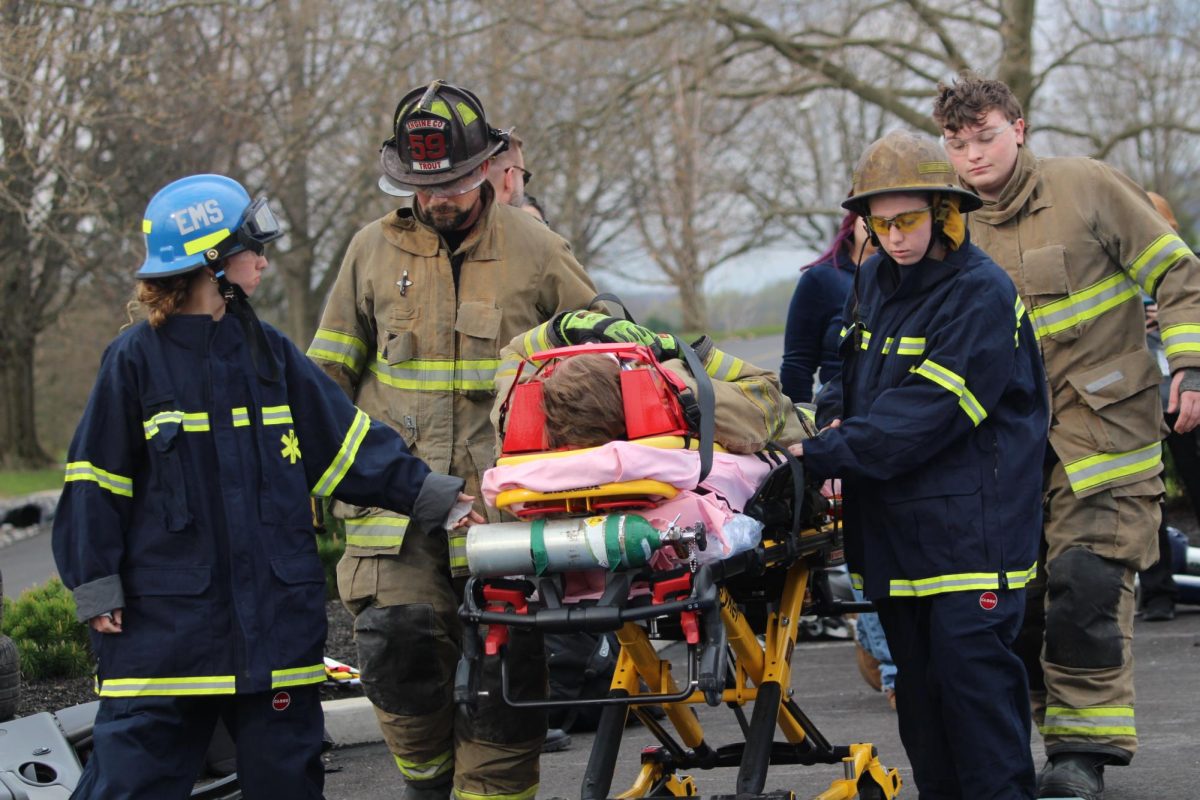 Students from the E.M.T. class get guidance from members of the Glen Rock fire department as they transport their ‘patient’ on a stretcher. EMTs focus on basic life support, while Paramedics have more advanced training and can perform more complex procedures. Especially when it comes to saving someone's life especially in life or death situations.  photograph by Peyton Elmore