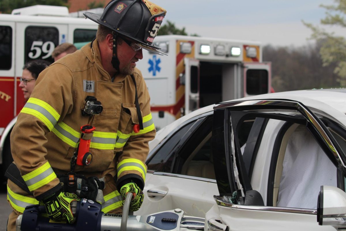  A Glen Rock firefighter from station 59 demonstrates to the students what they use “Jaws of Life” for when it comes to getting people out of cars. The "Jaws of Life" are a set of hydraulic rescue tools used by first responders to extricate people from vehicles or other situations after accidents when the doors are unable to be opened. Photograph by Josie Witsik
