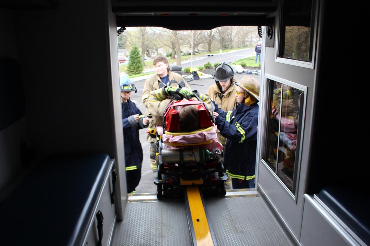 Glen Rock E.M.S Chief Ed Bailey, who is a former teacher at Susquehannock, explains to students the process of getting a ‘patient’ into an ambulance. 
 Stretchers, also known as gurneys, are used to safely and efficiently transport injured or ill individuals from accident scenes to ambulances, hospitals, or other medical facilities. Photograph by Josie Witsik 