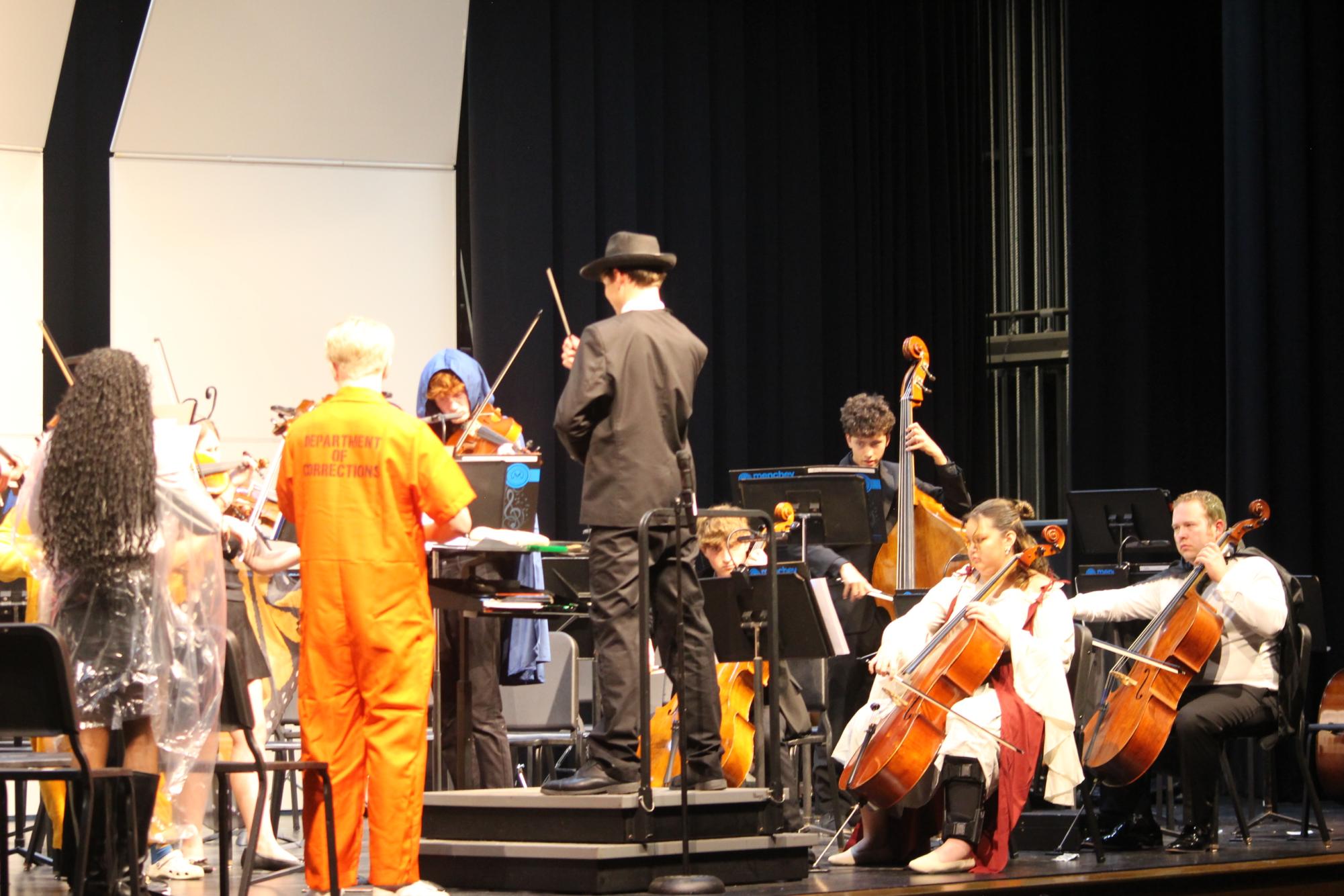 Junior Charles Schaffer directing his piece titled "Trick or Treat" in the selective strings ensemble. Photograph by Rhys Sanders