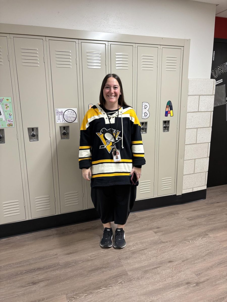 Special education teacher Emily Hedrick  shows off her swag as she represents a Penguins hockey jersey for Winter Sports Day. Senior student council member Caleb Ross comments on what he loved most about the holiday spirit week. “I really loved seeing everyone participate in all of the days, especially on the 2 days before break,” Ross said. “It was amazing to see how people that were dressed up contributed to the overall environment.” Photograph by Caroline Simpson