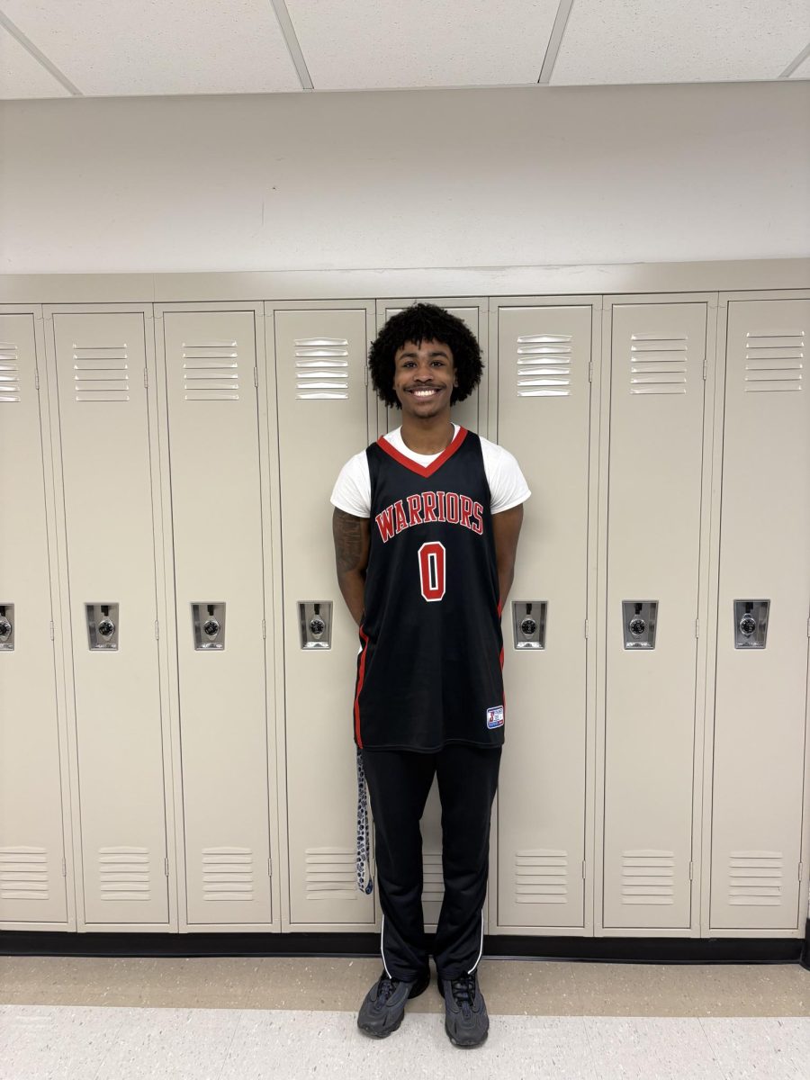 Senior Kaden Richardson dons his Warrior basketball jersey for ‘Winter Sports Day’ during the spirit week leading up to winter break. According to advisors, members of Student Council carefully selected themes they thought would be popular and students would participate in, while also trying to not be repetitive with previous spirit weeks from the school year. Photograph by Caroline Simpson