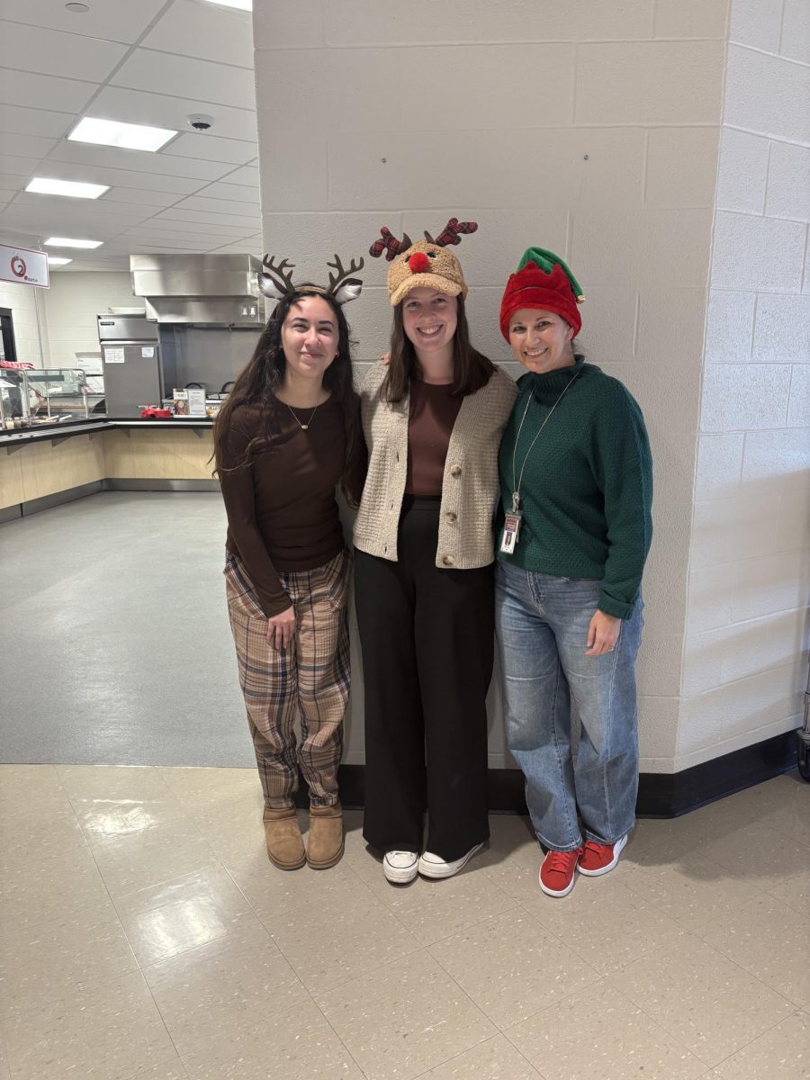 Junior Luna-Sofia Pastrana poses along with English teachers Kelly Porter and Katharine Wilt during ‘Winter Character Day.’ Porter was one of the most spirited teachers during the week.
“My favorite part of participating in holiday spirit week is how something as simple as me wearing a silly reindeer hat or festive pajamas can bring a smile to my students' faces and a little joy into our classroom," Porter said. Photograph by Caroline Simpson