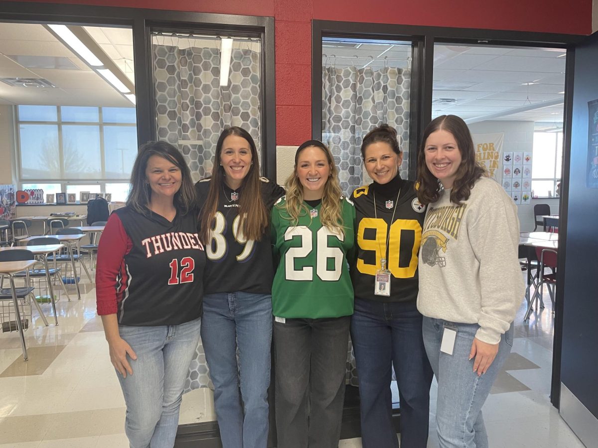 English teachers Erica Littleton, Jessica Beste, Emma Stiffler, Katharine Wilt, and Kelly Porter wear their gear for ‘Winter Sports Day’ on Dec. 16. Many teachers coordinated to dress up for spirit week highlighting their friendship and school pride. Photograph by Layla Holmes