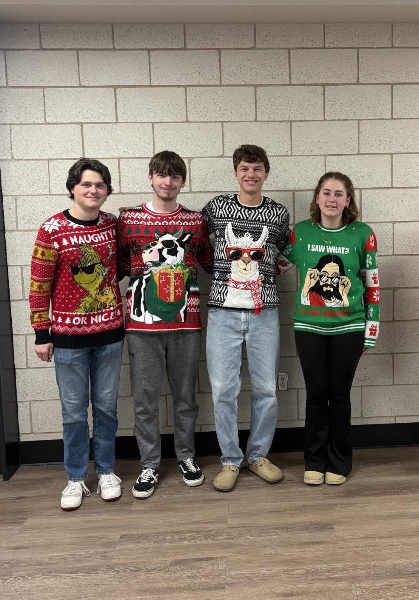 Seniors Christopher Vest, Jacob Motts, Caleb Ross, and sophomore Mallory Billet show off some impressive holiday-themed sweaters for spirit week. The Holiday sweaters with animals on them were very popular among the students for the holiday spirit week day; ‘Festive Sweater Day’. Photograph by Caroline Simpson
