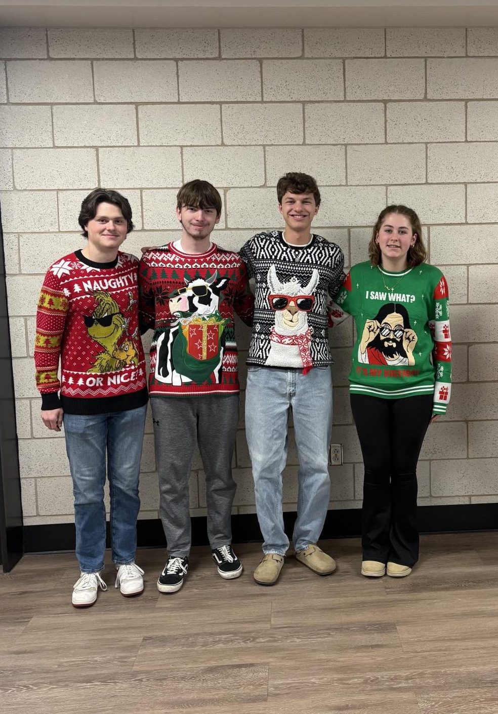 Seniors Christopher Vest, Jacob Motts, Caleb Ross, and sophomore Mallory Billet show off some impressive holiday-themed sweaters for spirit week. The Holiday sweaters with animals on them were very popular among the students for the holiday spirit week day; ‘Festive Sweater Day’. Photograph by Caroline Simpson