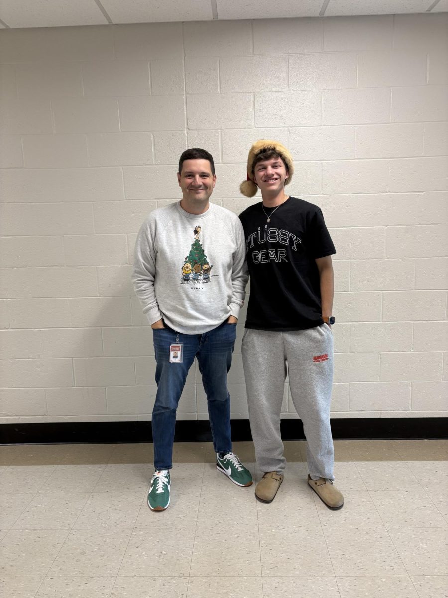 Social Studies teacher and Student Council co-advisor Andrew Warren and senior Student Council member Caleb Ross take a moment to pause for a picture during a Student Council meeting to promote and display school spirit during ‘Holiday Gear’ day on Dec. 22. Any time Student Council wants to host a spirit week they must receive approval from the school’s principal. This requires several days of planning well in advance of the event. Photograph by Caroline Simpson 