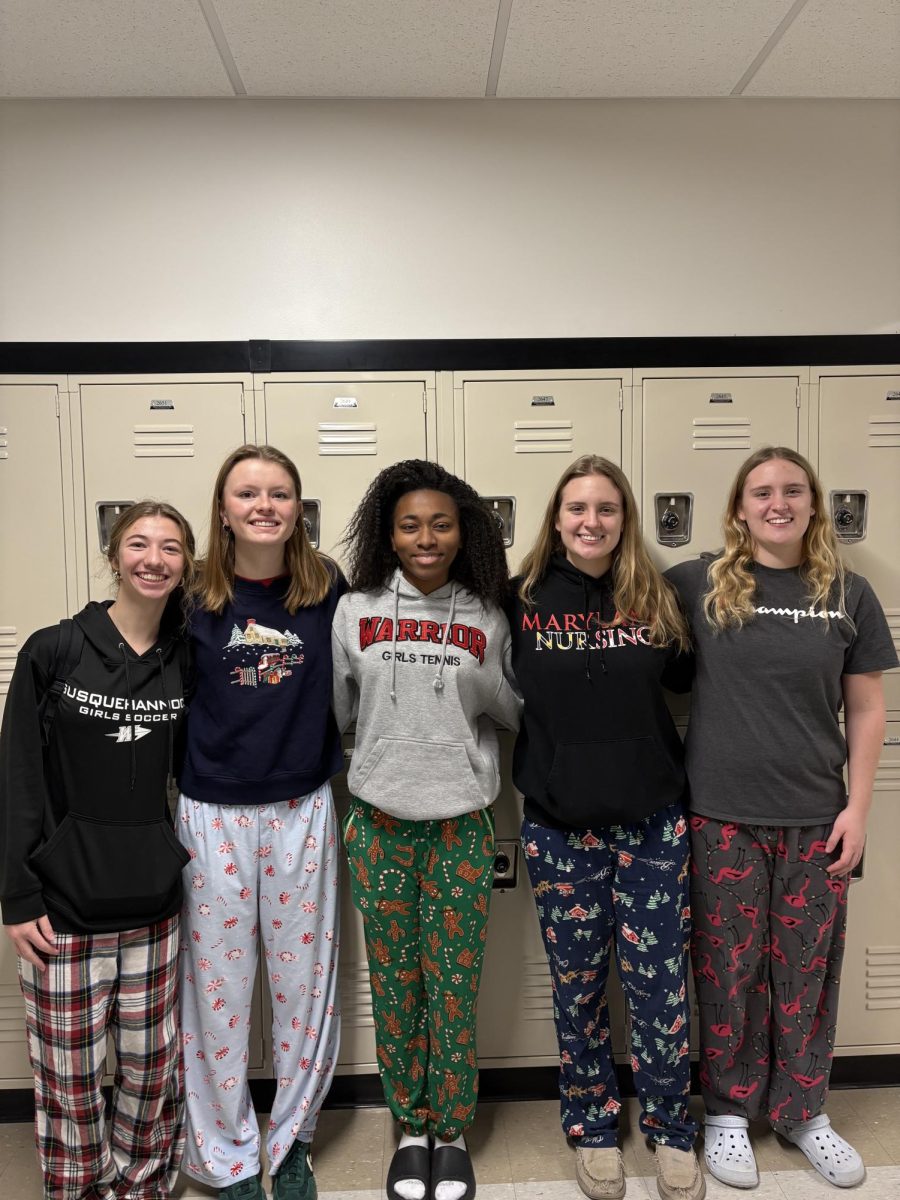 Seniors Emily Walker, Jillian Dance, Mackenzie Hodge, Stephanie Bauhaus, and Sarah Bauhaus take a moment away from class to show off their school spirit. The theme for the last day of spirit week was ‘Pajama Day.’ It also ended up being a day when the schools operated on a two-hour delay, so the theme was fitting. Photograph by Caroline Simpson