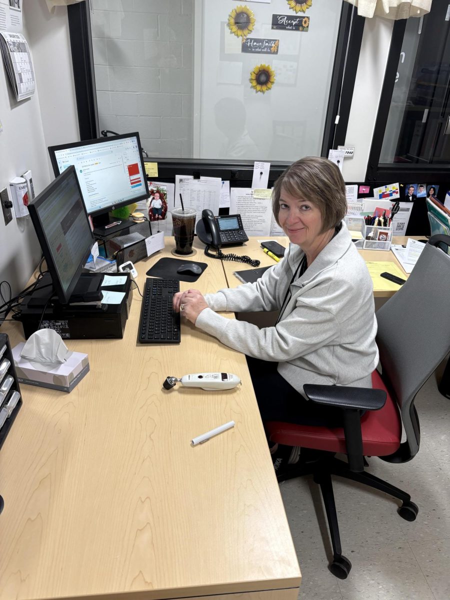 Melinda Landis working on her work as a nurse to keep everyone healthy during the school day.