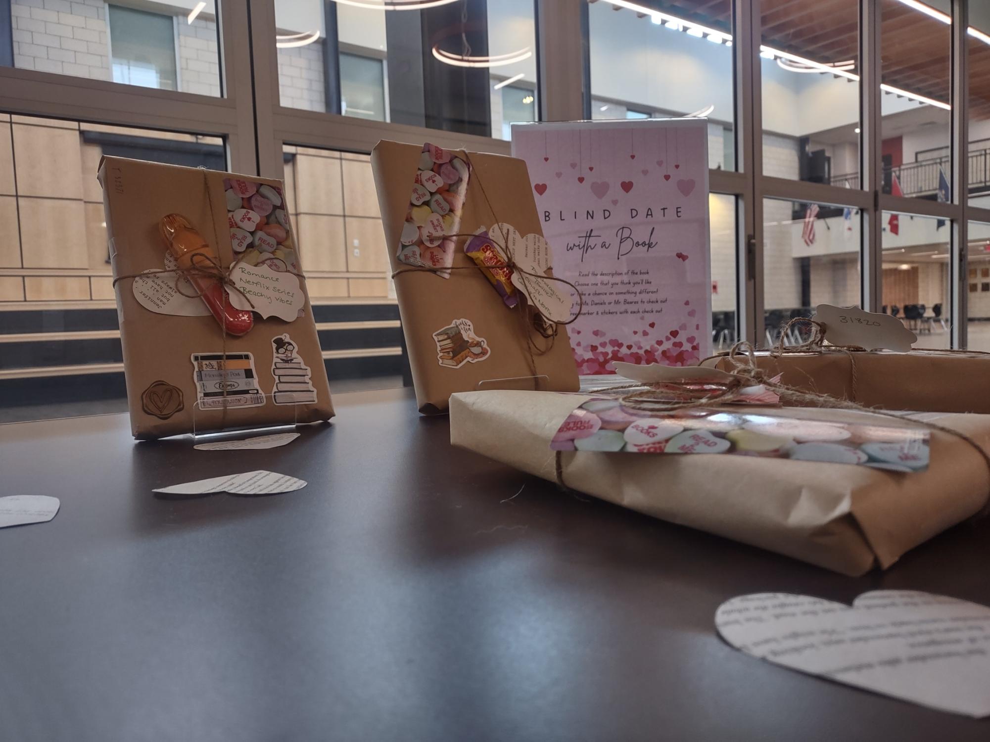 Wrapped books sit on a table within the library for another library initiative, “Blind Date with a Book.” Each book has a description that students can read before checking out the book. Photograph by Nathan Feeser