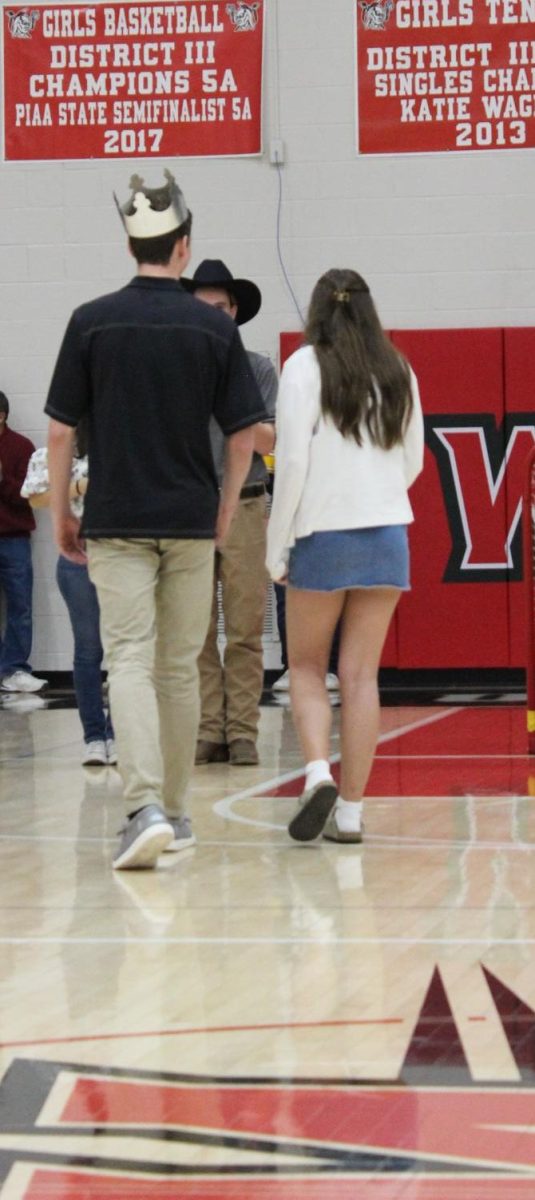 Senior Jackson Elliott walks back with junior Emily Border after being crowned Snow King. In total, Elliott collected 3.3 kg work of tabs to be donated to charity. Photograph by Josie Witsik