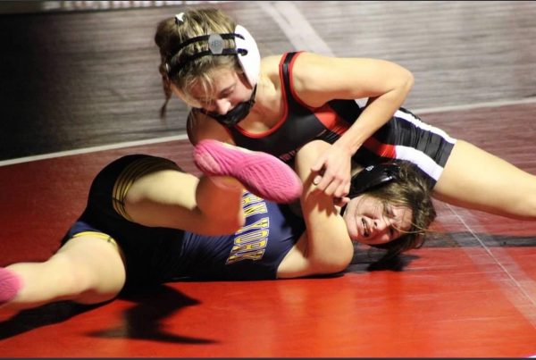 Junior Alyssa Martin attempts to pin her opponent. Martin eventually won her match via technical fall. 


Martin explains how she had to work around her opponent being tough. “At first I was a little bit shaky because I was nervous,” Martin stated. “Because she came at me first instead of me coming at her. So I was just like, okay, she's strong and stuff so I have to figure out how to work around that.”




Photograph Courtesy of Alyssa Martin 

