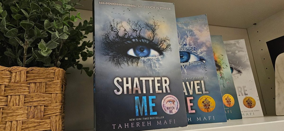 The book “Shatter Me” sits displayed in front of the next books in the series. Photograph by Lilly Kruzic

