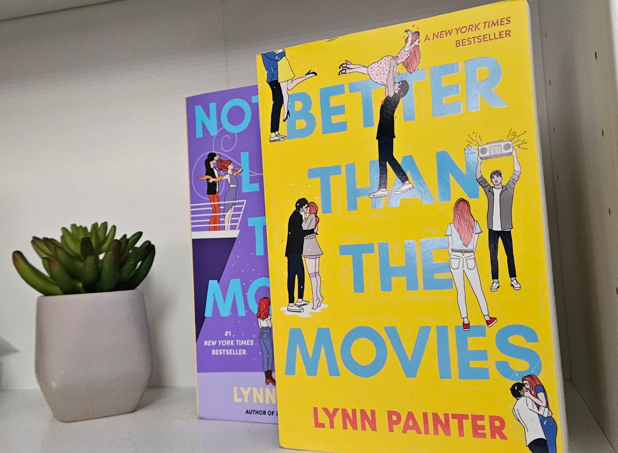 The book “Better Than the Movies” sits on a bookshelf in front of the next, optional, book in the series, “Nothing Like the Movies.” Photograph by Lilly Kruzic