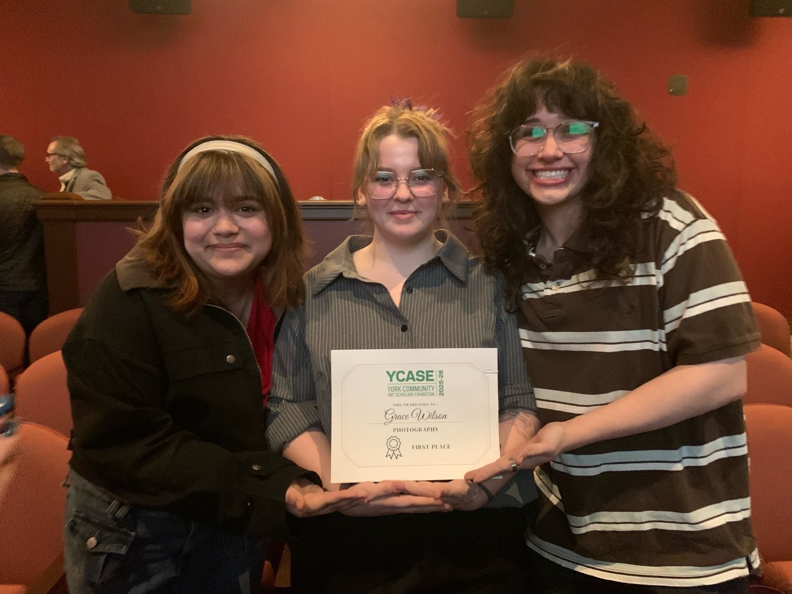 Senior Grace Wilson celebrating her first place win in the photography category with seniors Charlotte Rhoads and Josie Witsik
