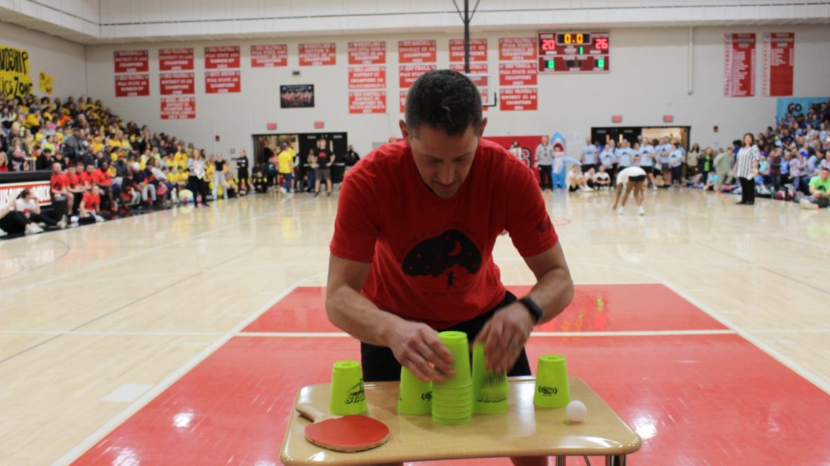 High school Electronic Arts teacher Wade Bowers pushes himself by stacking the cups as fast as he can so he can get the points for his team. 
¨I believe my favorite was the cup stacking, ping pong challenge. I love playing. ping pong, so I felt confident in that game.  I felt that there was no one specific event, but it felt like throughout the whole competition, we stayed positive and really cheered each other on even when we made mistakes. It was a variety of ages and we all worked well together. ¨ Bowers said. 
