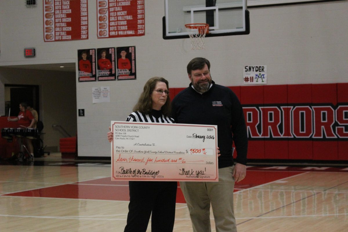  Chief Operations Officer Sue Green and superintendent Dr. Robert Bryson pose with a giant check denoting the funds raised for the Southern York County School District Foundation from the event. Roughly $9,700 was raised to go toward student scholarships. ¨It felt outstanding to be able to host such an awesome event that helps grow our pride in the school district and community while also being able to give back to the Foundation that does so much for the students within our district!'¨ Bryson said.
