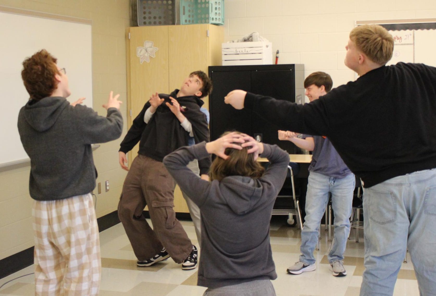 Sophomore Ezra Silliman acts out a random word, while the rest of his group, made up of sophomore Aiden Turk, sophomore Christian Krodel, junior Joe Brady and sophomore Noah Allen, reacts off of his lead to practice their improv acting skills. Photograph Courtesy of Kaiden Blackler
