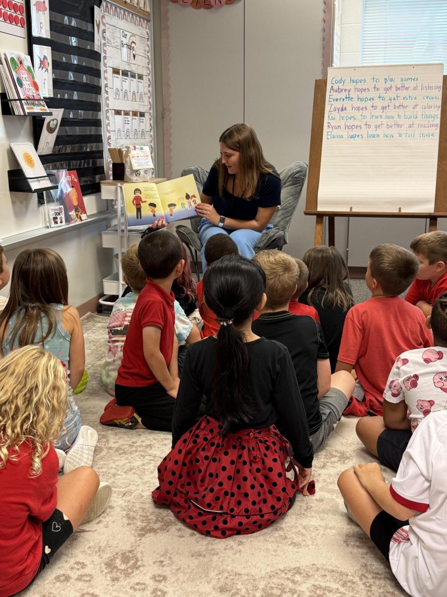 Parrish reads aloud to the first graders in her Career Practicum placement with Madison Collies at Shrewsbury Elementary. Photograph Courtesy of Julian Parrish