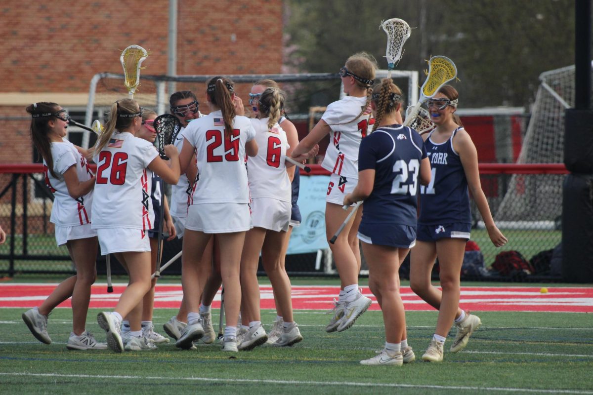 The team celebrates Park’s goal, as the score climbs further out of reach for the Bulldogs. Freshman Jorga Nace highlights the support both on and off the field, while sharing her favorite part of the season. “Team bonding," Nace said. "Even just going to Panera after a practice, or… hanging out with people on the team.” Photograph by Lucy Wherley